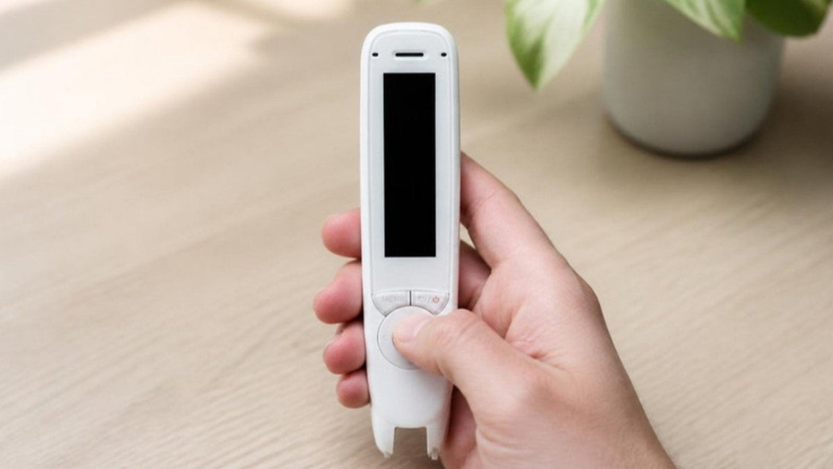 Hand pressing the button on a C-Pen Reader 2