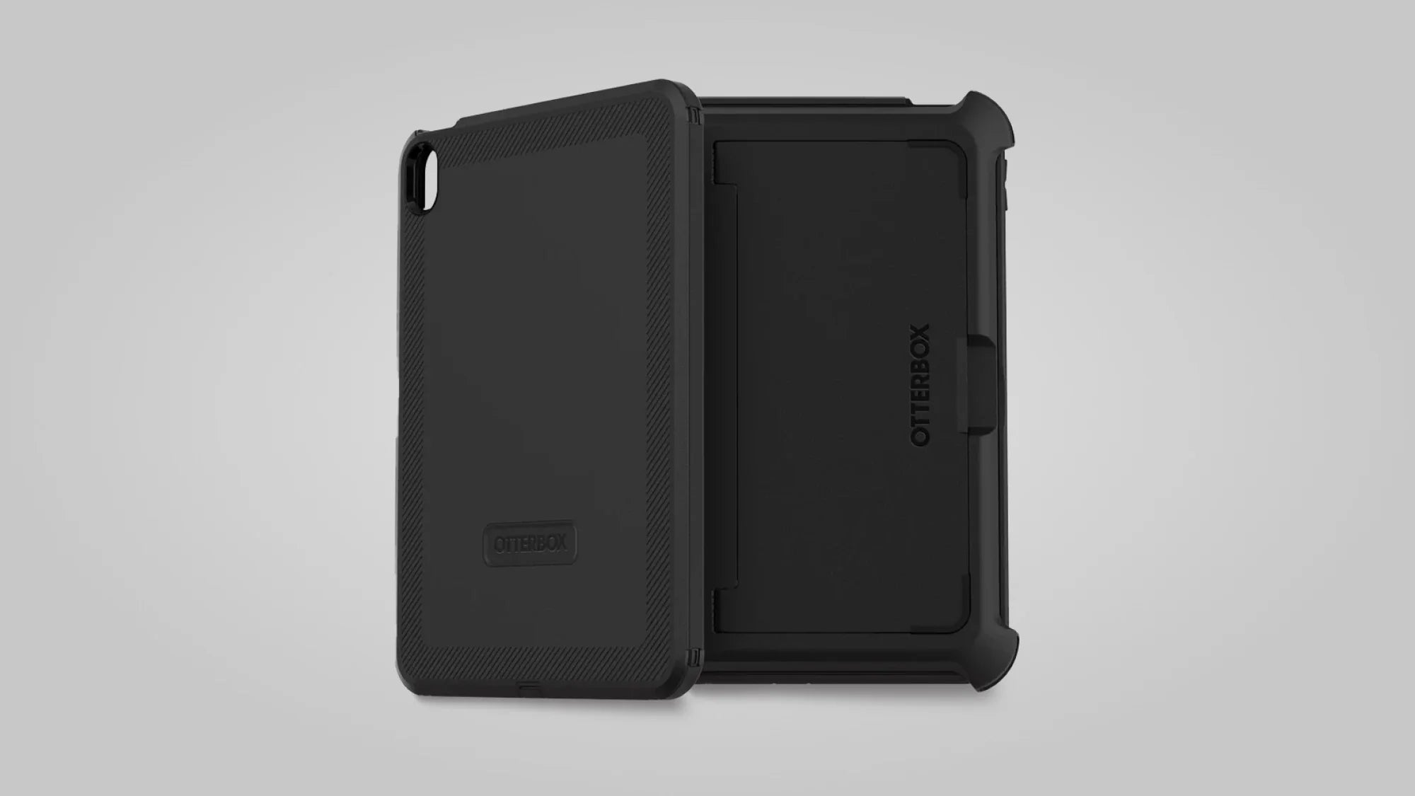 Two black OtterBox tablet cases are shown, one facing forward and one backward, displaying the rugged design and protective cover with the OtterBox logo visible on each case.