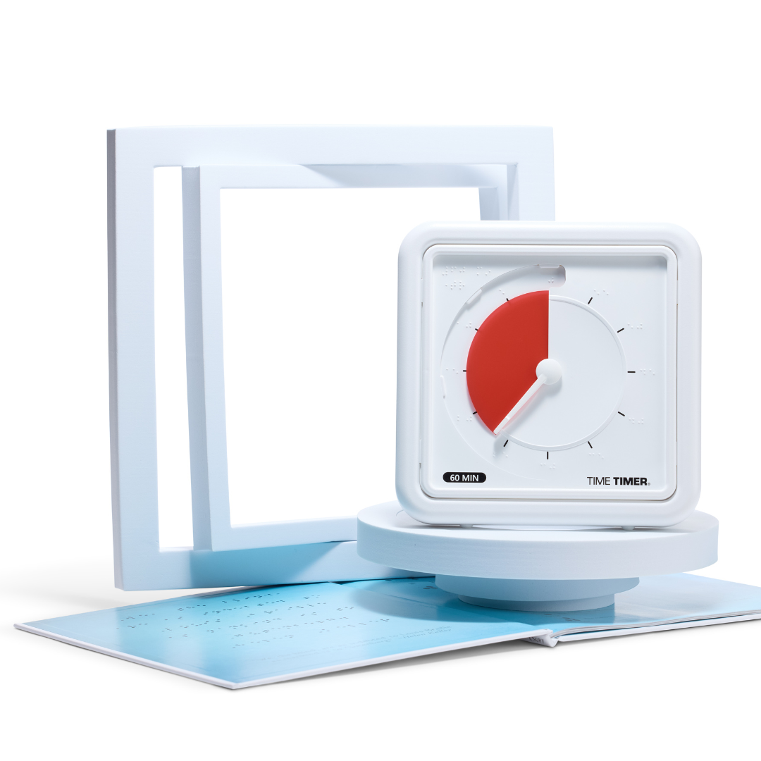 The Time Timer Braille (8 Inch) [Red Disk] by Time Timer sits on a round platform with open braille pages and a white frame behind it, all set against a clean white background, highlighting this accessible assistive technology timer.