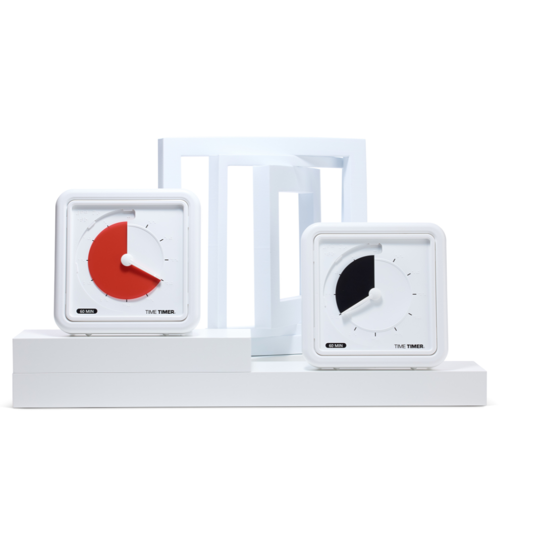 Two square Time Timer Braille (8 Inch) [Red Disk] devices by Time Timer are shown on white steps—one displays about 45 minutes (red disk), the other 30 minutes (black disk). A geometric white structure in the background highlights these assistive timers.