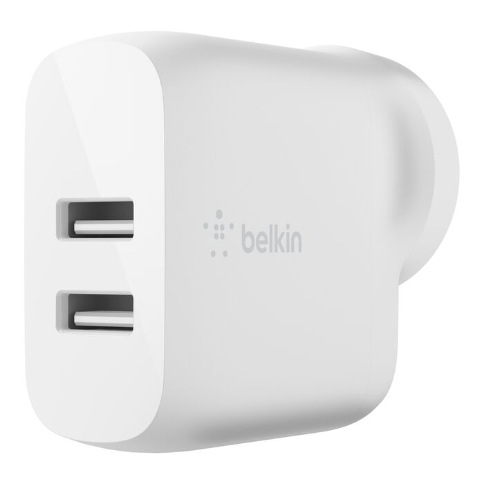 The Belkin 24W Dual USB-A Power Adapter in white is shown from an angled front view, featuring fast charging, a smooth rounded design, and the Belkin logo on the side.