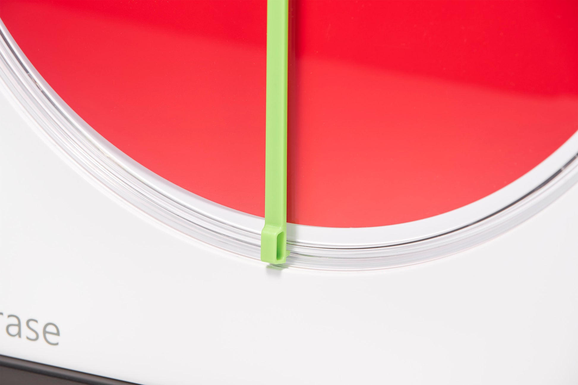 A close-up of the Time Timer MAX Extra Set Markers (3 Colours) by Time Timer shows a red disk and green hand at zero, with a mostly white background and part of a word visible in the lower left corner.