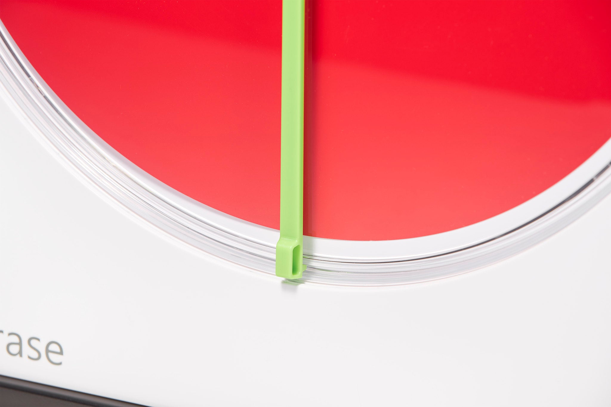A close-up of the Time Timer MAX Extra Set Markers (3 Colours) by Time Timer shows a red disk and green hand at zero, with a mostly white background and part of a word visible in the lower left corner.