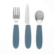 The KiddiKutter Kids Cutlery Set [Sky Blue] by KiddiKutter features a fork, serrated knife, and spoon with blue silicone handles, all displayed vertically on a white background.