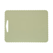 The KiddiKutter Silicone Cutting Board (Wavy) in Sage by KiddiKutter features a rectangular, non-slip design with scalloped edges and a handle cut-out, shown against a white background.