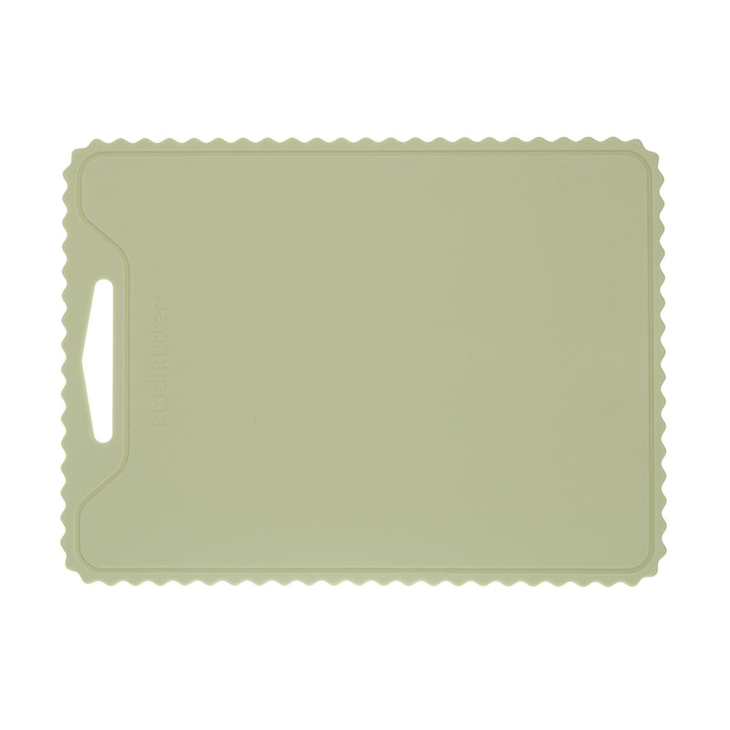 The KiddiKutter Silicone Cutting Board (Wavy) in Sage by KiddiKutter features a rectangular, non-slip design with scalloped edges and a handle cut-out, shown against a white background.