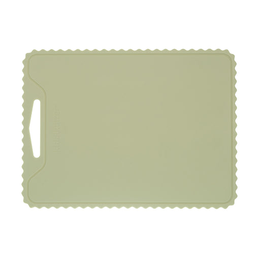 The KiddiKutter Silicone Cutting Board (Wavy) in Sage by KiddiKutter features a rectangular, non-slip design with scalloped edges and a handle cut-out, shown against a white background.
