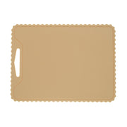 The KiddiKutter Silicone Cutting Board (Wavy) in cream by KiddiKutter features a rectangular, non-slip design with scalloped edges and a handle slot on the left, shown against a white background.