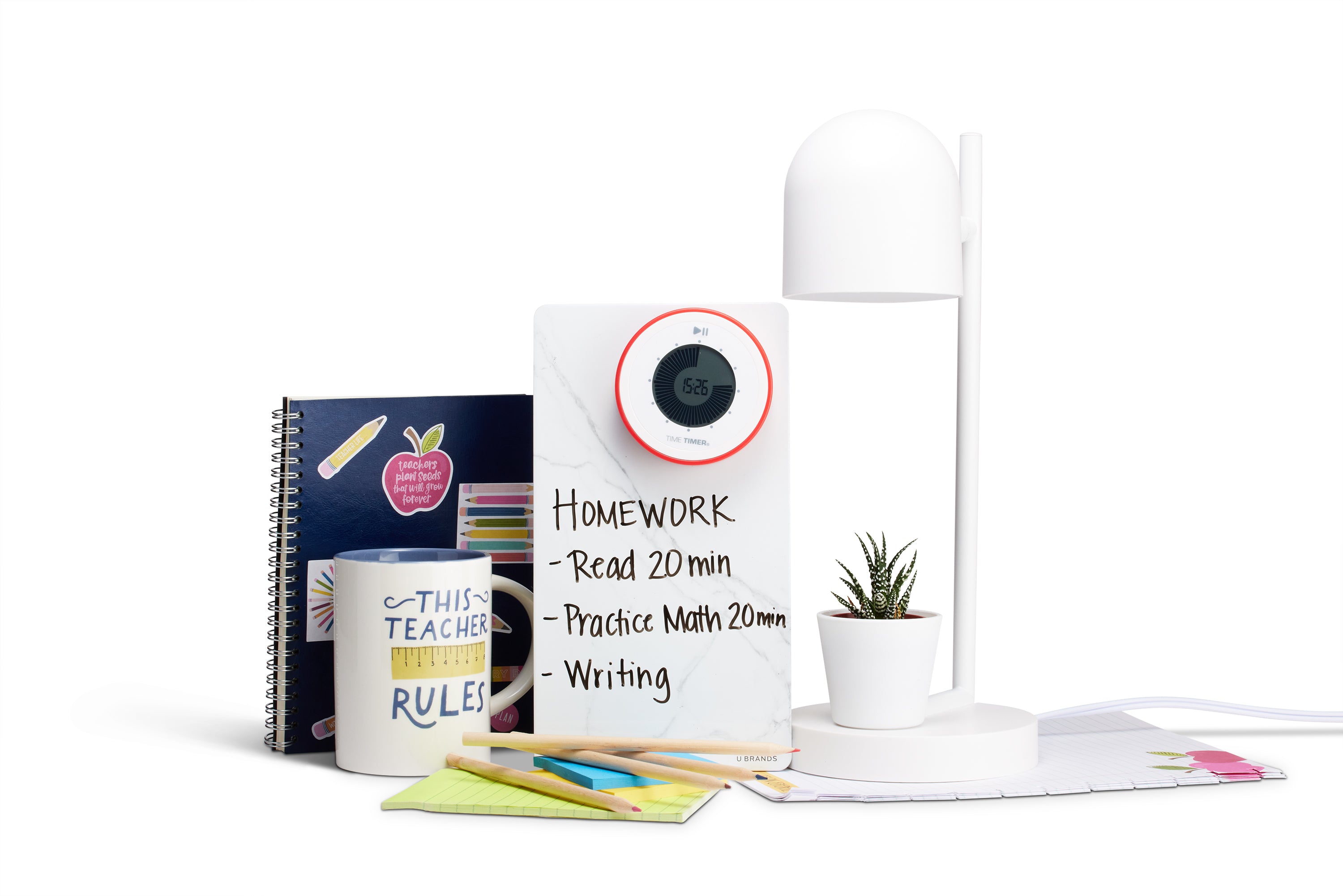A desk setup featuring a notebook, a "THIS TEACHER RULES" mug, colored pens, the Time Timer Twist with Kickstand (Red) by Time Timer, a homework whiteboard, a potted plant, and a modern white desk lamp.