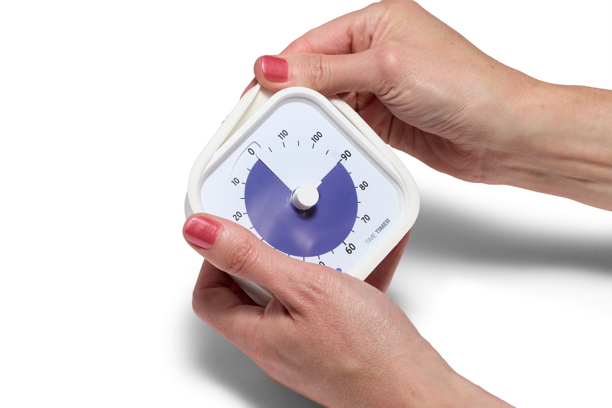 A person with red nail polish holds a white, square Time Timer MOD Education (120 min) by Time Timer, showing about 75 minutes left. The timer face is partially shaded blue for visual time management against a plain white background.