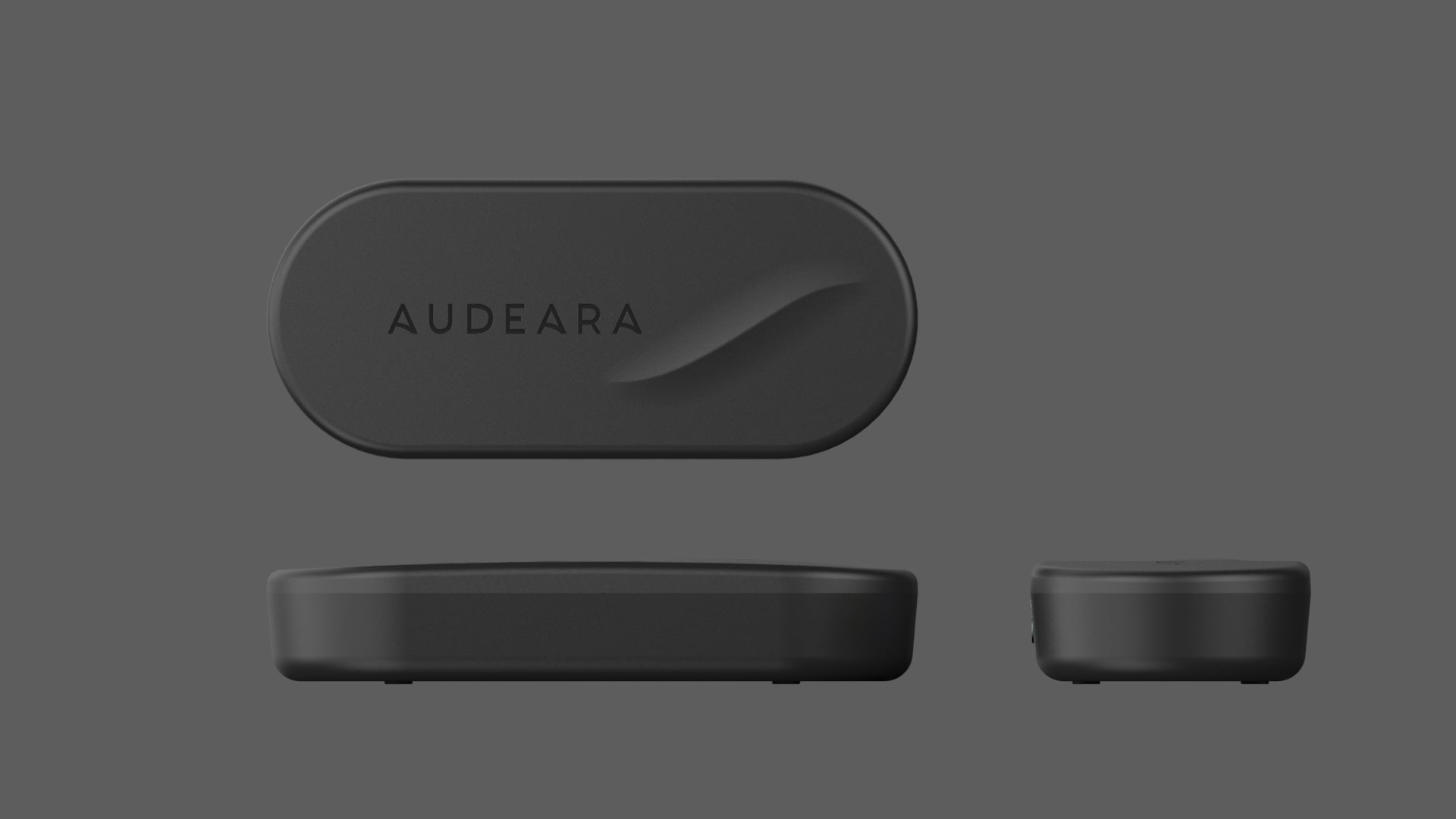 The Audeara Broadcaster (Auracast™ Transmitter) by Audeara is a sleek, rectangular black device with rounded edges and “AUDEARA” on top, shown from multiple angles against a gray background. Designed for inclusive listening.