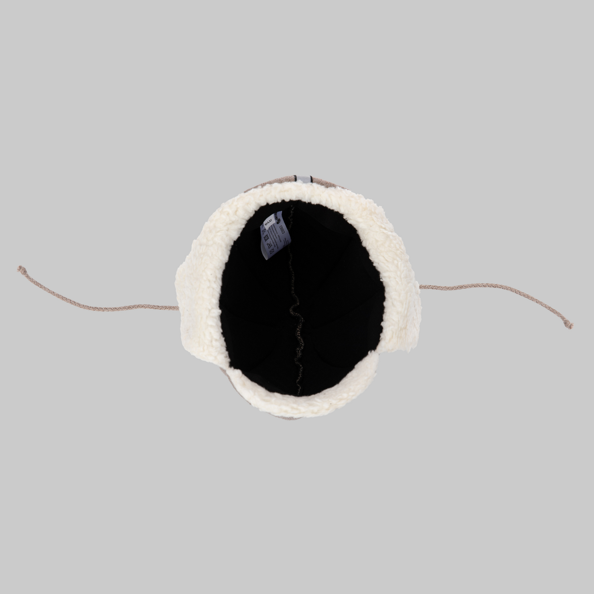 Top view of the Ribcap Bieber Kids Beanie [Brown] by Ribcap, a winter hat with furry white lining, brown drawstrings, and a black interior label, displayed on a plain gray background—cozy and stylish for safe wear.
