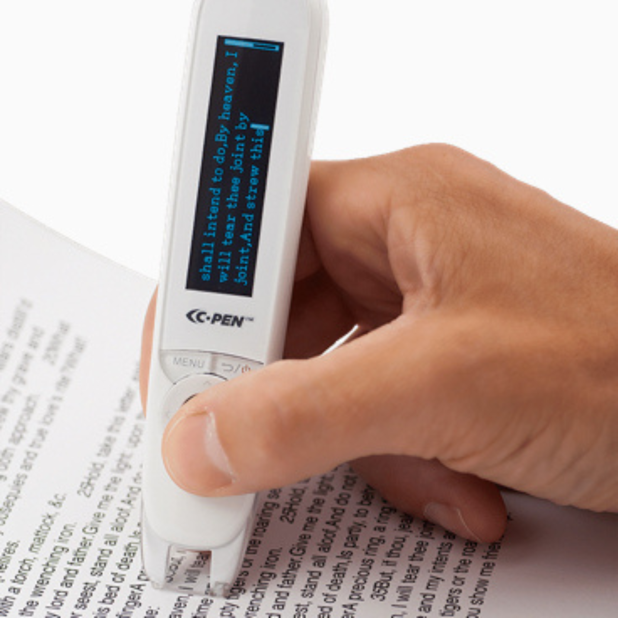 A hand uses the C-PEN C-Pen Reader 2 to scan and highlight text from a printed document. This assistive tool shows the scanned text in blue on its digital screen with a black background.