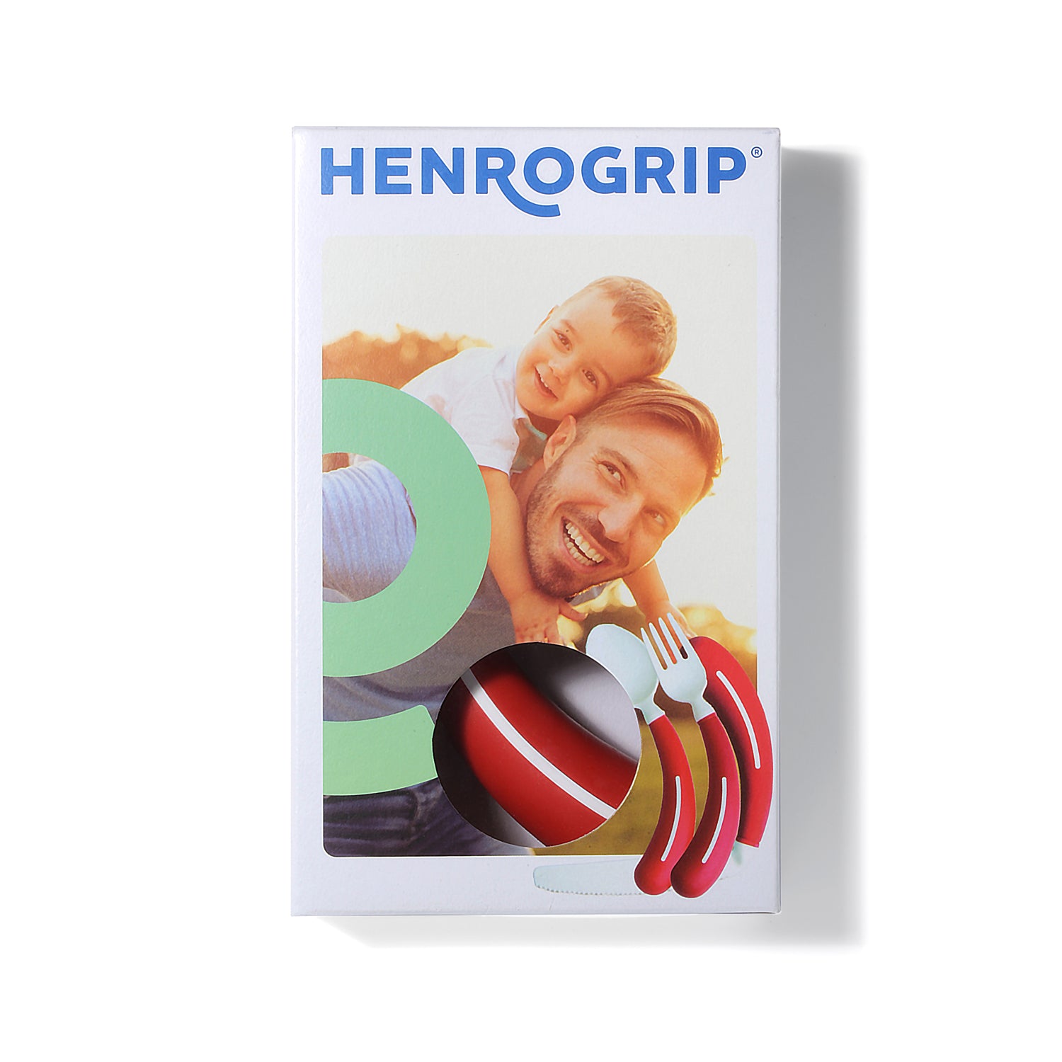 A box from Assistive Tech labeled "HenroGrip Spoon - Red (Left-Handed) | Ergonomic Adaptive Cutlery" shows a smiling man carrying a child, with a circular window displaying the ergonomic red adaptive spoon inside.
