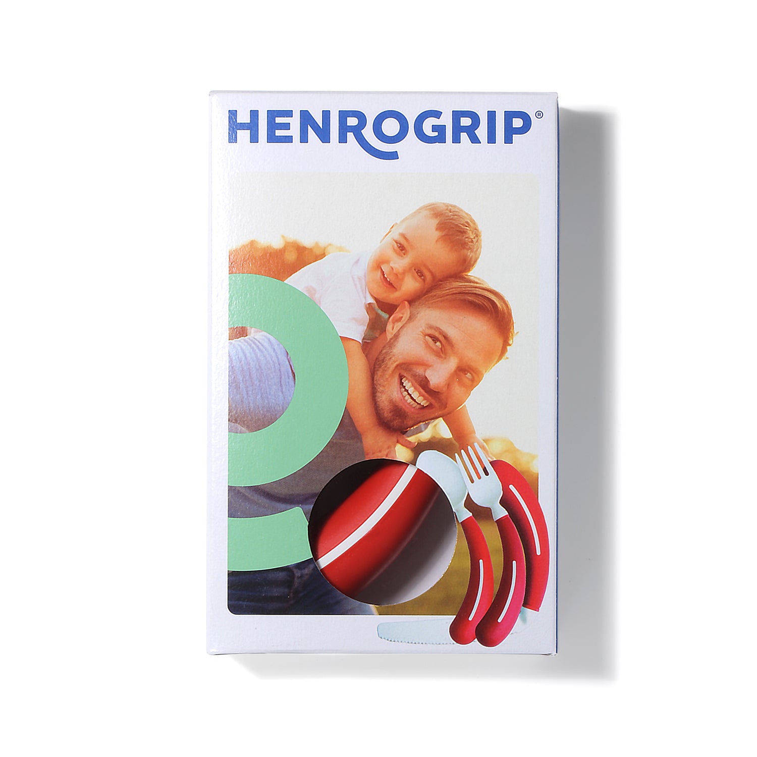 A Henrotek HenroGrip Cutlery Bundle [Red] (Right) box shows a smiling man giving a young boy a piggyback ride, with the red and white ergonomic cutlery set visible through the packaging window.