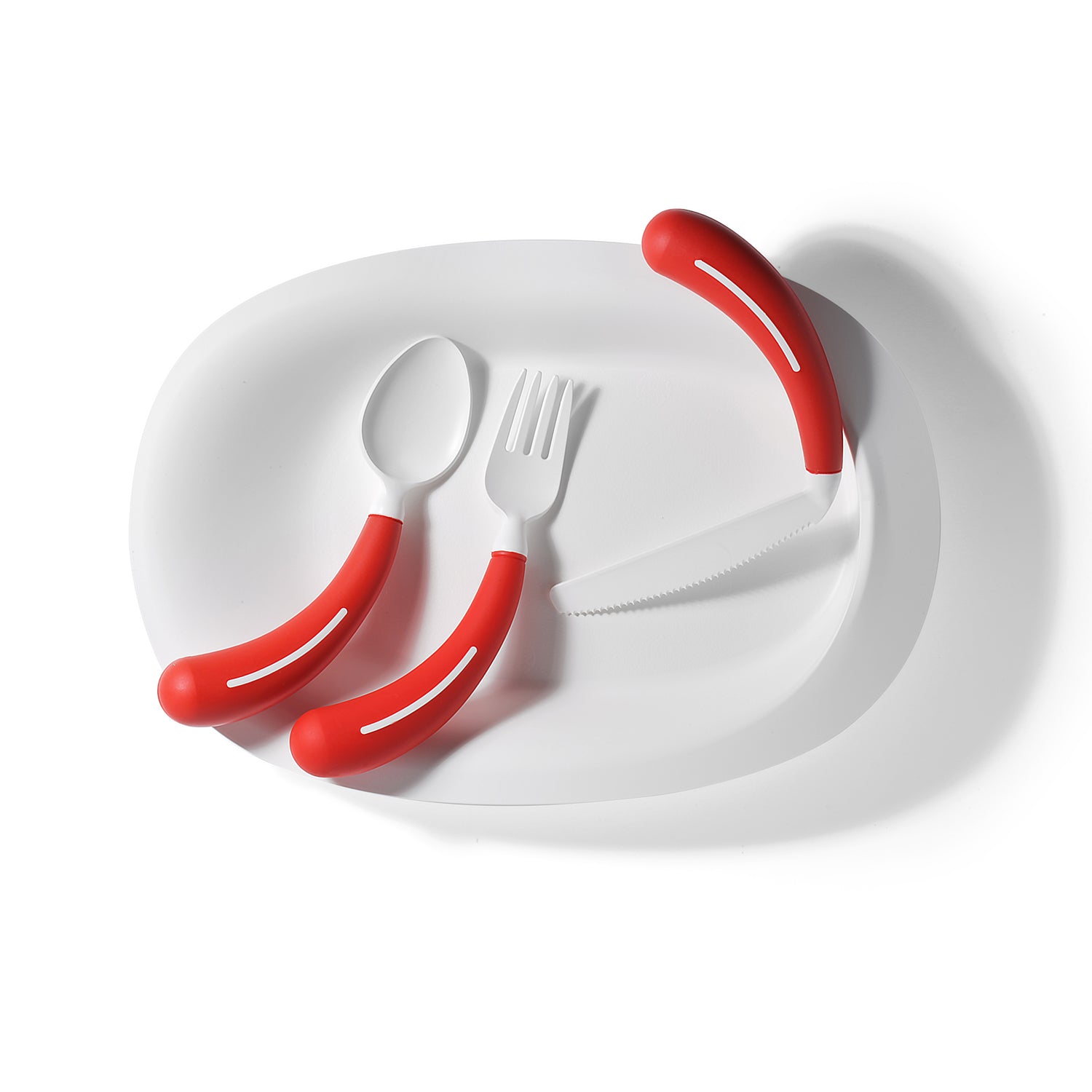 The Assistive Tech HenroPlate, a white adaptive plate, holds a spoon, fork, and knife with bright red easy-grip curved handles—neatly arranged for one-handed eating on a clean white background.