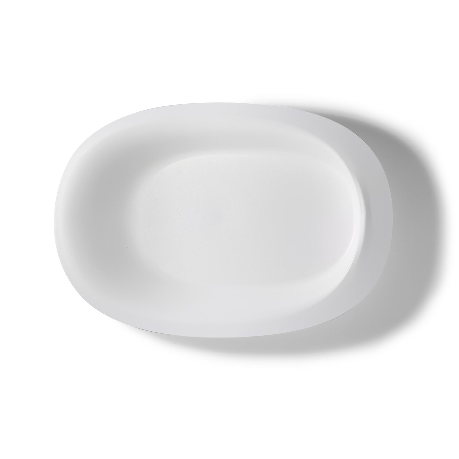 The Assistive Tech HenroPlate, an adaptive sloped white oval-shaped plate with smooth edges, is shown from above on a plain white background with a soft shadow cast to the right.