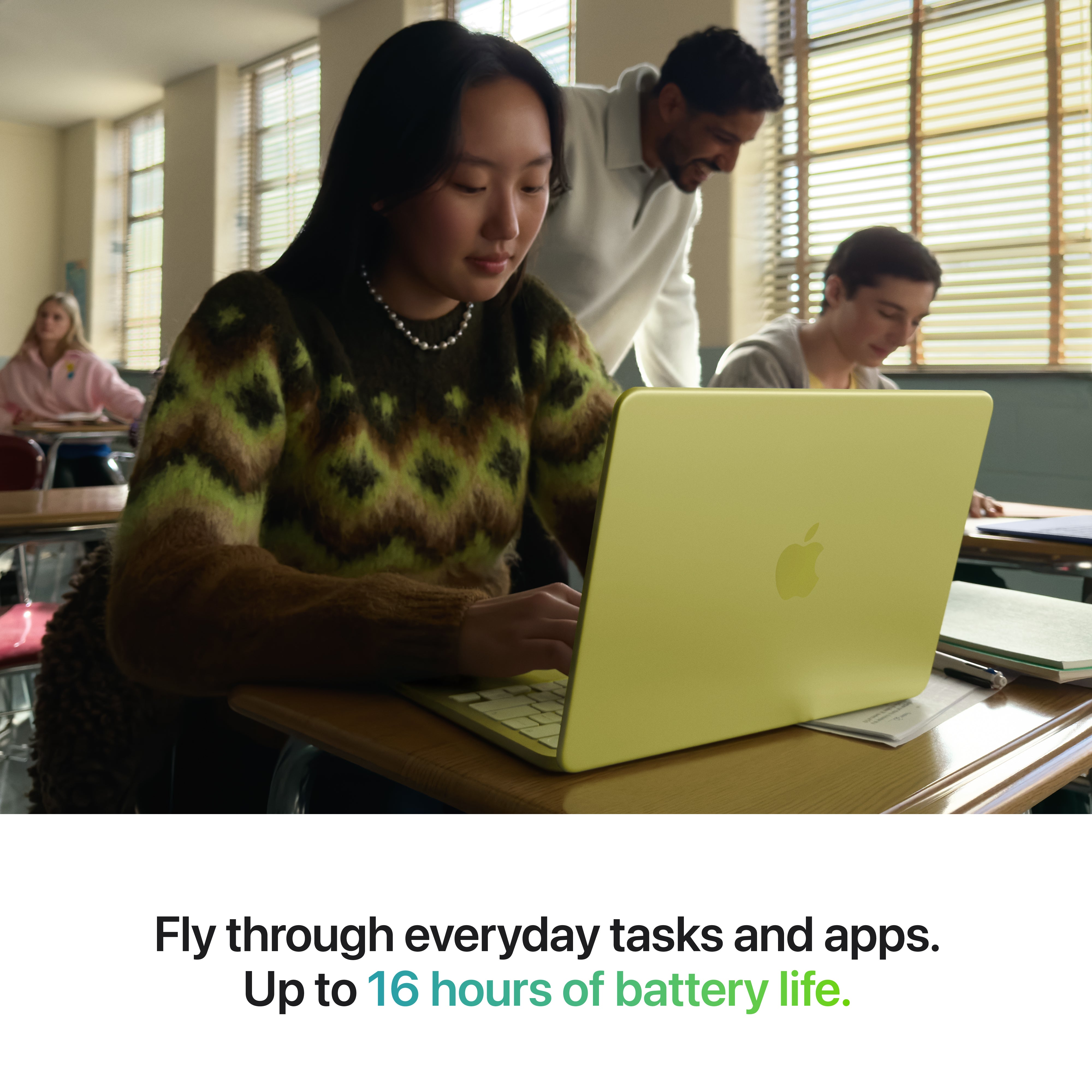 A student uses an Apple MacBook Neo with a vibrant Liquid Retina display in class. Caption: Power through daily tasks and apps—up to 16 hours of battery life.