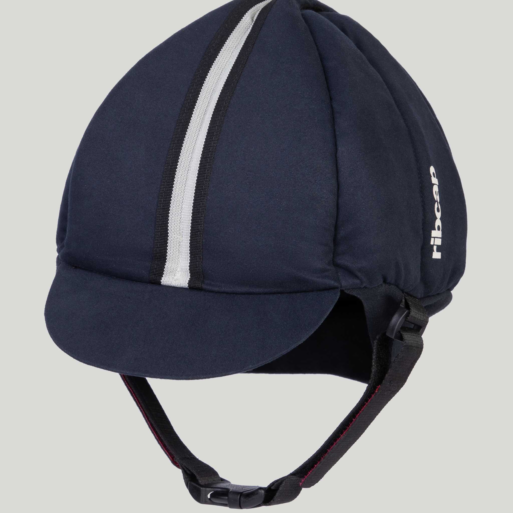 The Ribcap Hardy Protective Helmet Cap [Navy Blue] by Ribcap is a soft protective helmet with a short brim, white vertical stripe on top, black adjustable chin straps, and "ribcap" printed in white—ideal as a medical protective helmet.