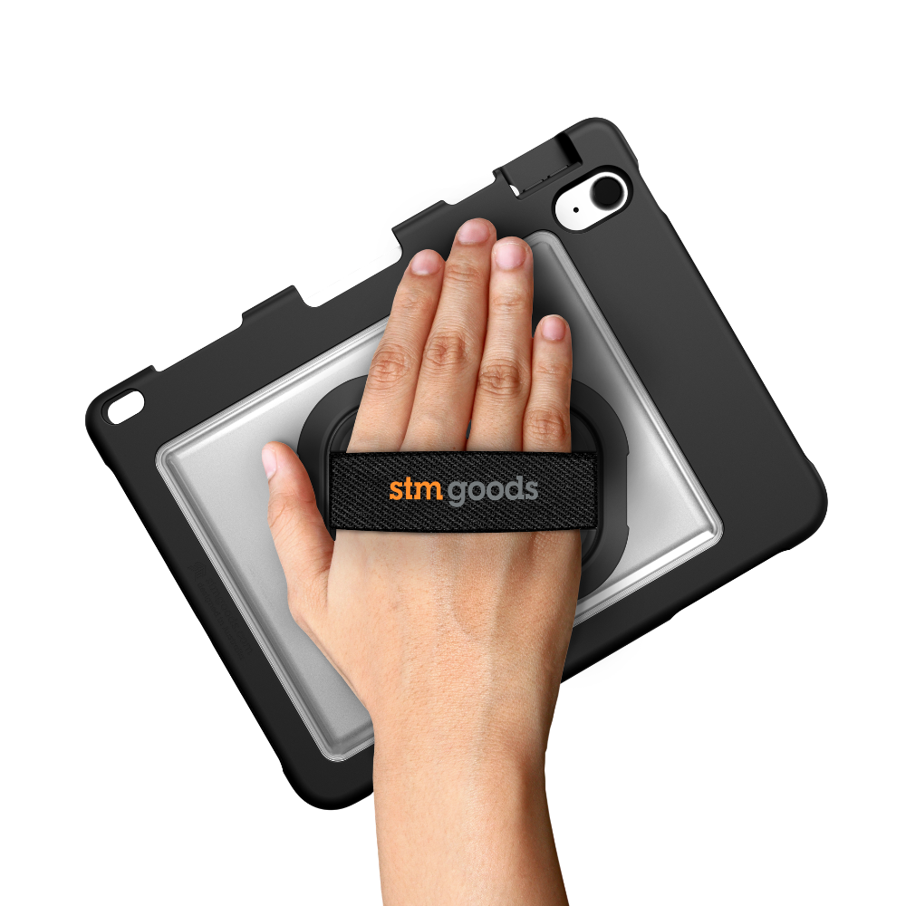 A hand holds the STM Swivel Case [Black] for iPad A16/10th/11th Gen, featuring a built-in rotating hand strap by STM for secure and comfortable grip.