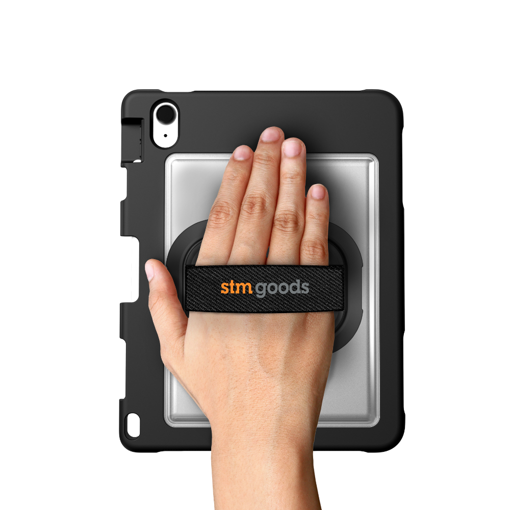 A hand grips an iPad in the STM Swivel Case [Black] (for iPad A16/10th/11th Gen) by STM, using the secure rear strap branded with “stm goods.”.