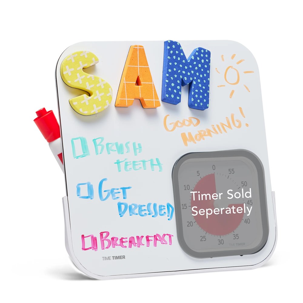The Time Timer Dry Erase Board by Time Timer is a white magnetic board with colorful foam letters spelling SAM, a sun drawing, and a visual schedule—Brush teeth, Get dressed, Breakfast. Includes red marker and timer slot (timer sold separately).