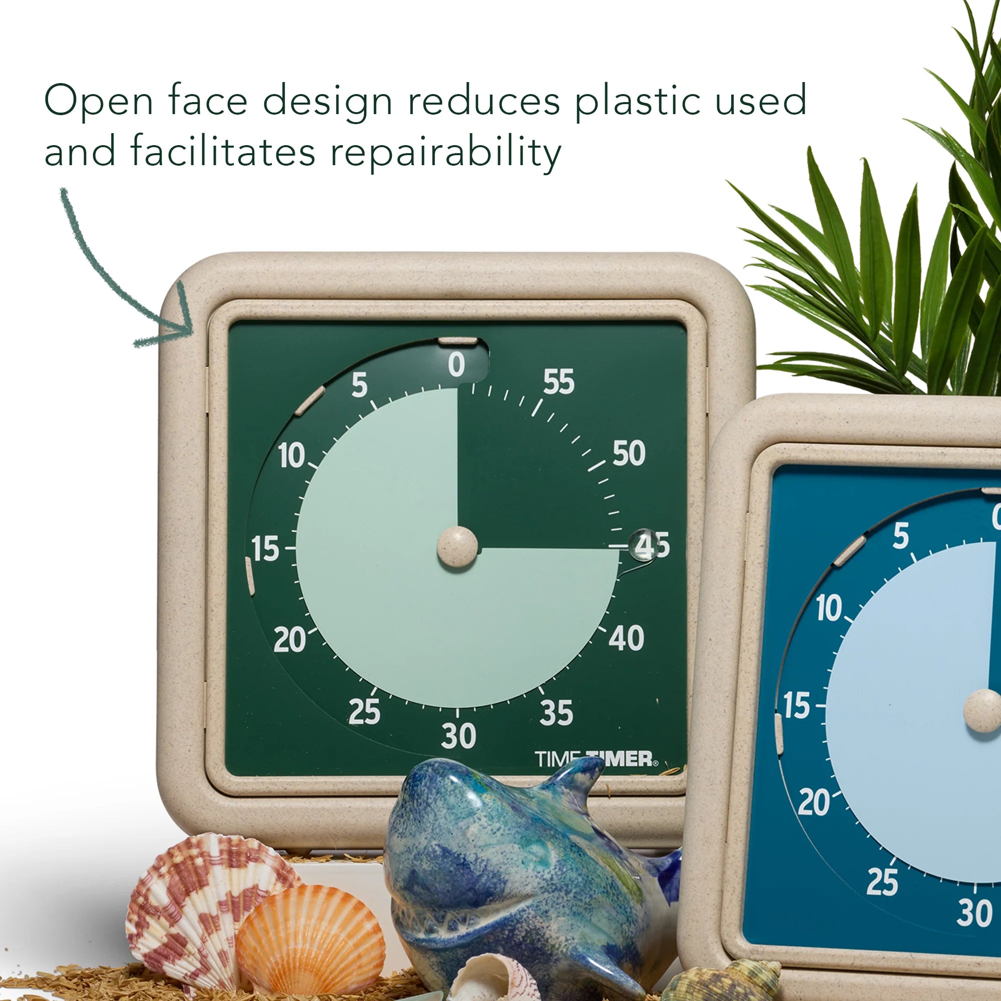 Two Time Timer Retro Eco (8 Inch) [Water/Blue] timers by Time Timer are shown among seashells, a plant, and a blue fish ornament. Above, text states: "Open face design reduces plastic use and improves repairability.