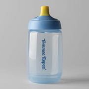 A Tommee Tippee Active Spout Cup 390mL for toddlers (12m+) with a leak-proof spout lid, in blue and yellow, stands upright on a plain gray background.