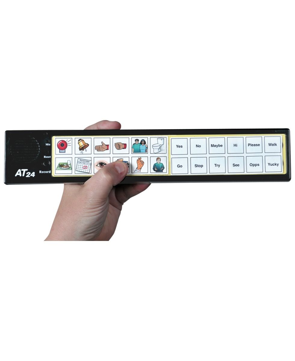 A hand holds the Attainment 24 Talker with Glove by Attainment, an AAC device with illustrated buttons for words like Yes, No, Hi, Please, Go, and Yucky—each paired with clear icons for assistive communication.