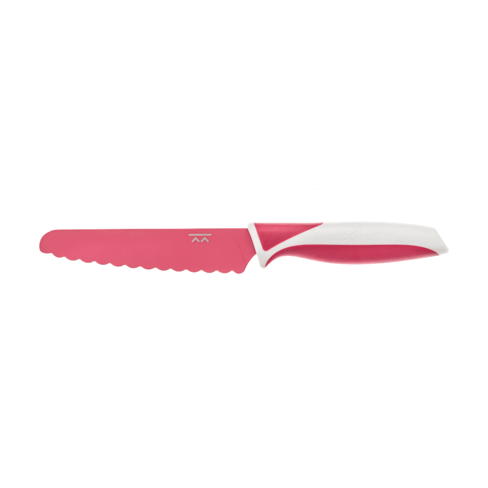The KiddiKutter Knife [Dusty Pink] by KiddiKutter features a child-safe, serrated plastic blade and a rounded tip, making it ideal for kids or kitchen beginners learning to help safely. White and pink handle design.