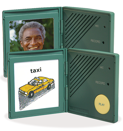 The Attainment Talking ID - Personal Talker is a green, hinged device with record and play buttons, displaying a photo of a smiling man on one side and a yellow taxi illustration on the other—ideal for assistive communication.