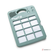 A green GoTalk 9+ Lite Touch AAC device by Attainment with nine square buttons, speaker, and top control buttons, designed for assistive communication. “GoTalk 9+” logo and Attainment branding are visible.