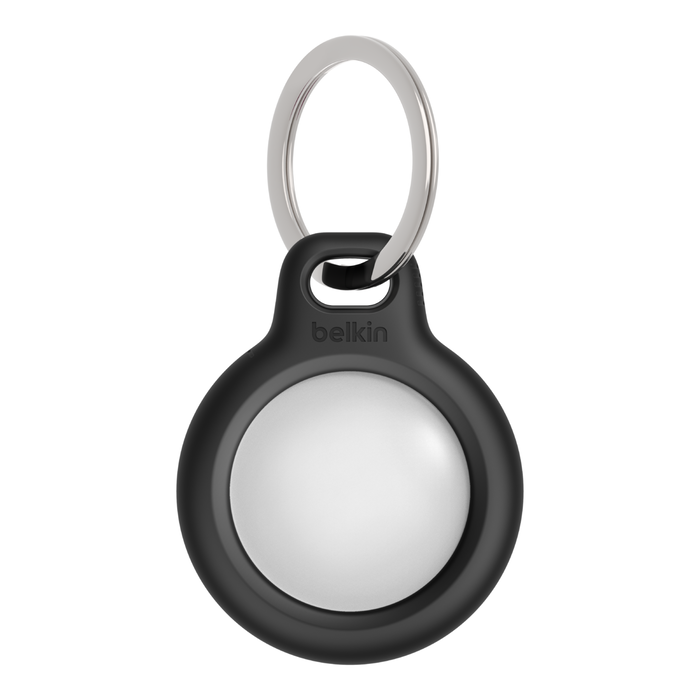 A black Assistive Tech Secure Holder keychain holds a circular silver Apple AirTag (2nd Gen) from the 4 Pack bundle, with a silver keyring attached for easy use with Apple's Find My network.