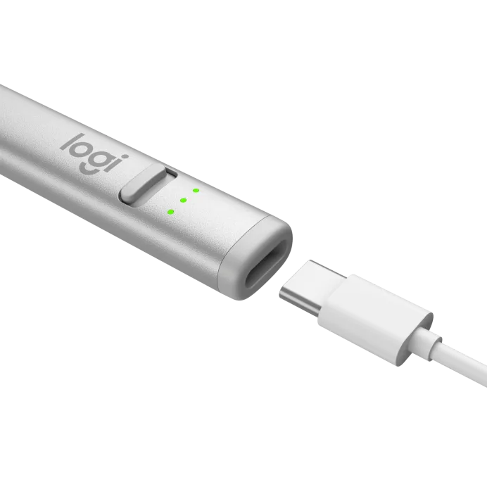 A close-up of the silver Logitech Crayon Stylus USB-C for iPad 10th Gen, featuring logi branding, three green LEDs, and a USB-C charging port, shown beside its USB-C charging cable.